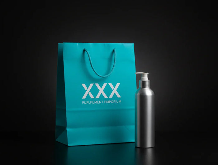 Black background aqua blue shopping back with "XXX" and "fulfillment Emporium" text on it. Silver oil bottle outside of and in front of bag.